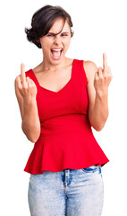 Sticker - Beautiful young woman with short hair wearing casual style with sleeveless shirt showing middle finger doing fuck you bad expression, provocation and rude attitude. screaming excited