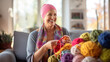 © EmmaStock - A cancer patient sat happily knitting in the living room