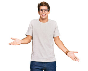 Wall Mural - Handsome caucasian man wearing casual clothes and glasses smiling cheerful with open arms as friendly welcome, positive and confident greetings