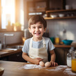 Caucasian kid with smile dressed as a chef in the kitchen.