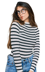 Poster - Young beautiful teen girl wearing casual clothes and glasses making fish face with lips, crazy and comical gesture. funny expression.