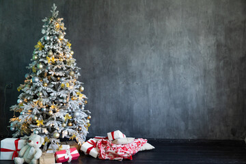 Wall Mural - Christmas tree for new year with gifts in dark grey room interior