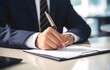 © Oleksiy - Businessman hands writing on clipboard on blurred office background