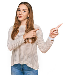 Wall Mural - Young blonde woman wearing casual clothes smiling and looking at the camera pointing with two hands and fingers to the side.