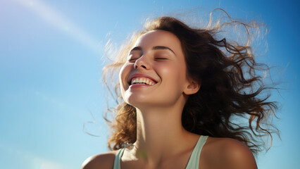 Wall Mural - A Brunette woman breathes calmly looking up isolated on clear blue sky