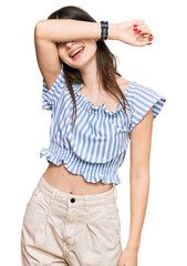 Canvas Print - Young beautiful caucasian girl wearing casual clothes covering eyes with arm smiling cheerful and funny. blind concept.