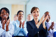 © STEEX/peopleimages.com - Corporate, people and applause for presentation at conference, workshop or seminar in New York. Diverse group, female manager and excitement in audience with smile, happy and clapping for speaker