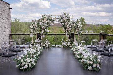 Wall Mural - Wedding ceremony. Very beautiful and stylish wedding arch, decorated with various fresh flowers, standing in the garden.