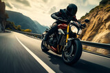 Fototapeta  - Man rides a motorcycle in a curved asphalt road with rural and mountain background