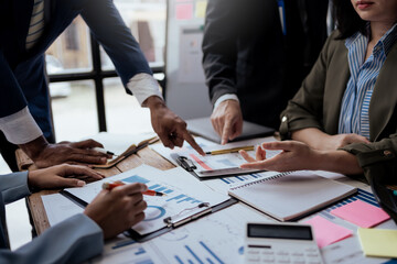 Business people meeting. Close up of hands business people working together in meeting, brainstorming, discussing and analyzing and planning business strategy.