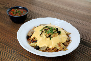 Wall Mural - Chicken liver noodles and cheese with chickpea, tomato and chilli sauce served in dish isolated on table side view of arabic food