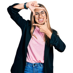 Canvas Print - Hispanic young woman wearing business jacket and glasses smiling making frame with hands and fingers with happy face. creativity and photography concept.