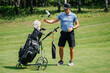 © Nadzeya - Professional older golfer takes one of clubs out of bag playing outdoors