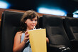 © ADDICTIVE STOCK - Girl with popcorn enjoying movie in theater