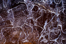 Top View Of Ice With Water Bubbles And Cracks