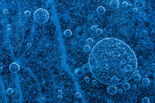Top View Of Blue Bubbles Under Frozen Water Surface
