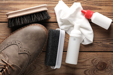 Wall Mural - Brogue shoes with Shoe care products and accessories on a wooden background