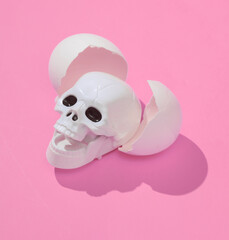 Wall Mural - Creative layout with skull and eggshell. Bright pink background with shadow. Visual halloween trend. Minimalistic aesthetic still life. Fresh idea