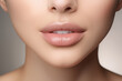 Subtle nude lip gloss on a woman's lips, close-up shot. Minimalist makeup for a natural, everyday look. Perfect for poster, banner, or design. High-resolution image. Female beauty and elegance