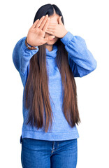 Wall Mural - Young beautiful chinese woman wearing casual turtleneck sweater covering eyes with hands and doing stop gesture with sad and fear expression. embarrassed and negative concept.