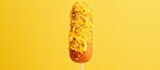 Fototapeta  - Mustard-covered fried sausage on a homemade corn dog stick.