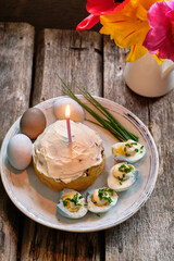 Wall Mural - Easter table setting with tulips, Easter cake and eggs