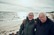 © Davor - Happy senior man and woman old elderly couple walking on cold beach