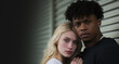 Young Interracial Couple Concept - copy space - teen love, blond pale skinned white teen girl leaning her head on a handsome black afro teen boy of color