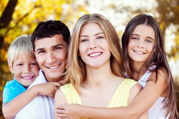 Wall Mural - Happy young family walking together in park