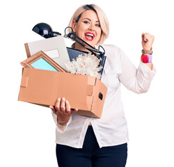 Wall Mural - Young blonde plus size woman fired holding box screaming proud, celebrating victory and success very excited with raised arms