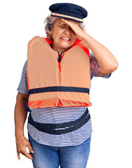 Poster - Senior woman with gray hair wearing nautical lifejacket stressed and frustrated with hand on head, surprised and angry face