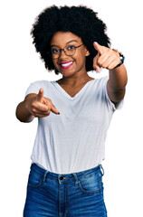 Sticker - Young african american woman wearing casual white t shirt pointing to you and the camera with fingers, smiling positive and cheerful