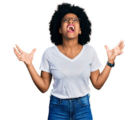 Poster - Young african american woman wearing casual white t shirt crazy and mad shouting and yelling with aggressive expression and arms raised. frustration concept.