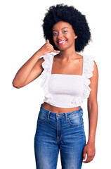 Poster - Young african american woman wearing casual clothes smiling doing phone gesture with hand and fingers like talking on the telephone. communicating concepts.