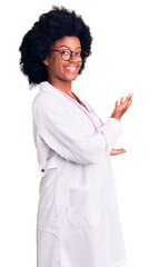 Poster - Young african american woman wearing doctor coat and stethoscope inviting to enter smiling natural with open hand