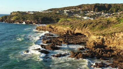 Poster - Sandstone rocks at Caves beach Pacific coast of Australia – aerial flying as 4k.
