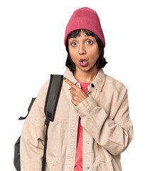 Wall Mural - Young student with backpack and beanie in studio trying to listening a gossip.