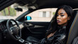 Portrait of a sensual black woman with leather attire in sport car