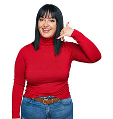 Poster - Young hispanic woman wearing casual clothes smiling doing phone gesture with hand and fingers like talking on the telephone. communicating concepts.