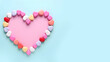 Heart made of colorful candy on a blue background.  Valentine's Day, BIrthday concept.