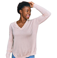 Wall Mural - Young african american girl wearing casual clothes smiling confident touching hair with hand up gesture, posing attractive and fashionable