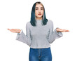 © Krakenimages.com - Young modern girl wearing casual sweater clueless and confused expression with arms and hands raised. doubt concept.
