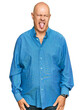 © Krakenimages.com - Middle age bald man wearing casual clothes sticking tongue out happy with funny expression. emotion concept.