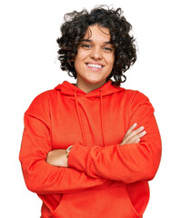 Canvas Print - Young hispanic woman with curly hair wearing casual sweatshirt happy face smiling with crossed arms looking at the camera. positive person.