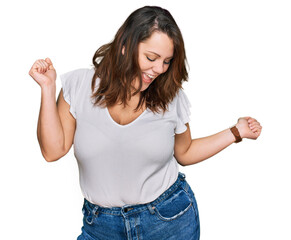 Young plus size woman wearing casual white t shirt dancing happy and cheerful, smiling moving casual and confident listening to music