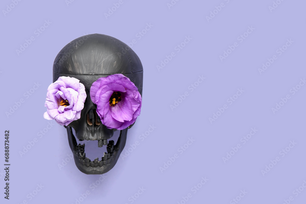 Black human skull with beautiful flowers on purple background