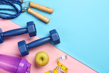 Poster - Flat lay composition with dumbbells on color background, space for text