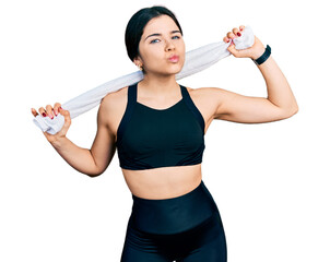 Poster - Young brunette woman with blue eyes wearing sportswear and towel looking at the camera blowing a kiss being lovely and sexy. love expression.