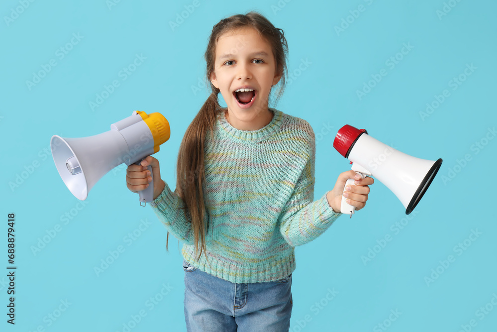 Little girl with megaphones on blue background