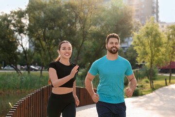 Sticker - Healthy lifestyle. Happy couple running outdoors on sunny day